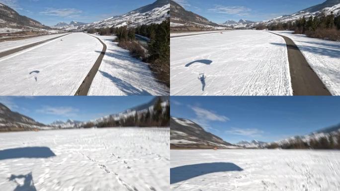 翼服飞行者降落在白雪皑皑的瑞士山区