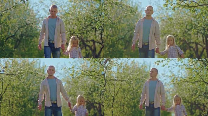快乐的父亲和金发小女孩在春天的4K，Prores走在美丽的公园里