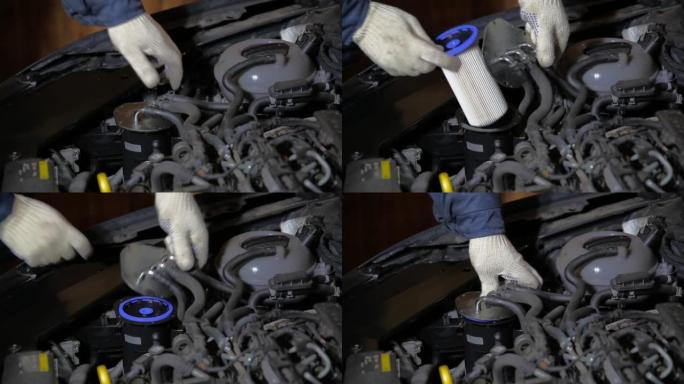 汽车修理工在汽车上安装了新的燃油滤清器。燃油滤清器更换和燃油系统维护，特写