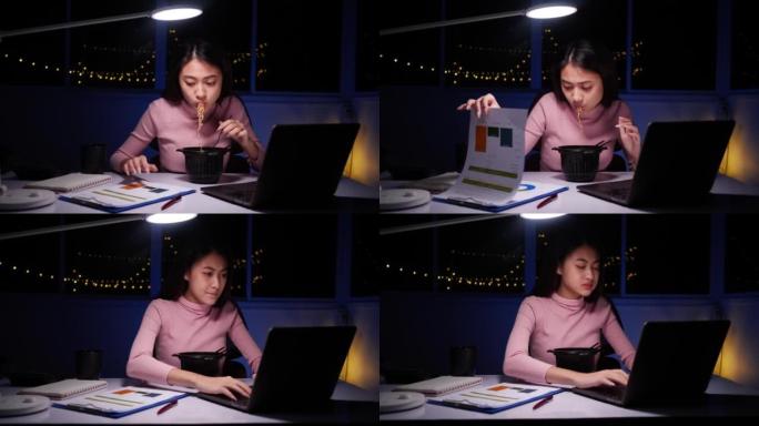 亚洲女商人在晚上在家笔记本电脑上工作时吃方便面