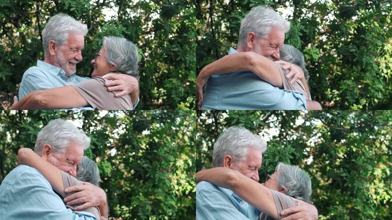可爱的老夫妇拥抱在户外一起玩乐。爱和感情概念。男人和女人拥抱。