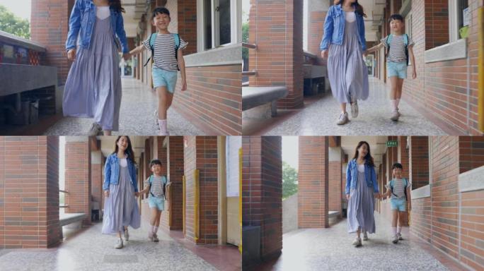 年轻的亚洲母亲带她的小女儿上学