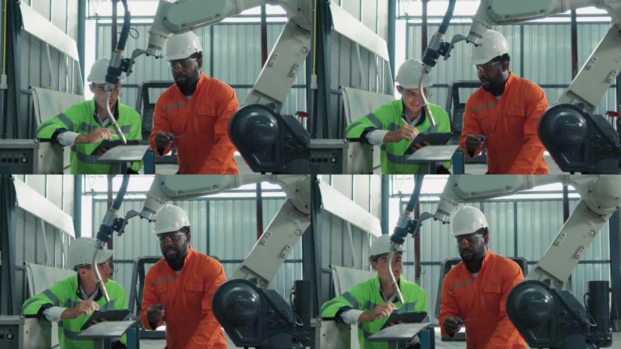 保护工作服的技术工程师小组控制和指导工厂中工业机器人的机械臂的维护