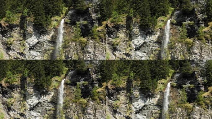 在夏天，阳光明媚的日子里，在欧洲，绿色和岩石的悬崖中间的瀑布，在法国，朝着阿尔卑斯山的博福特。