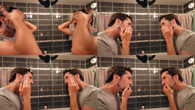 男人在镜子前洗面奶洗脸