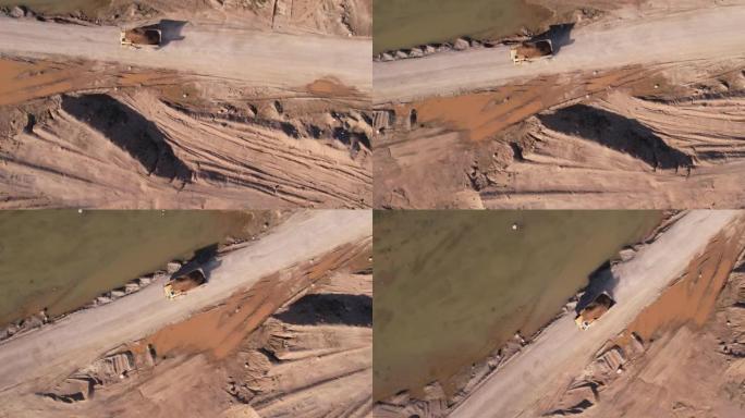 露天矿卡车运输砂，无人机视图。露天矿的沙子运输。在采石场拖运卡车。