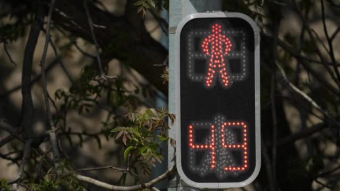 特写行人过路交通灯，红色交通灯变绿。给行人开绿灯。白天的城市街道。4k