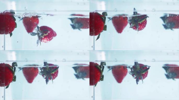 水中的草莓，新鲜的浆果掉落并漂浮