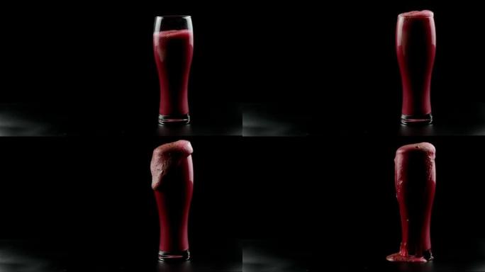 黑色背景上的啤酒杯溢出红色泡沫饮料