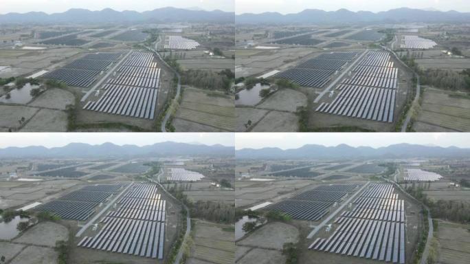 日落时太阳能电池板农场的鸟瞰图