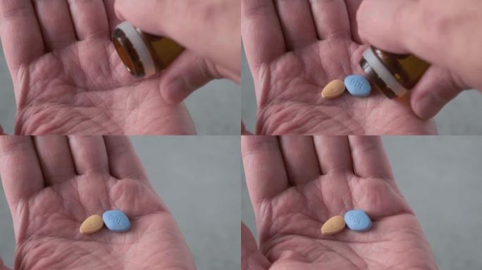 男人在治疗勃起功能障碍和前列腺炎的手部药物中服用蓝色和棕色药丸。勃起药物
