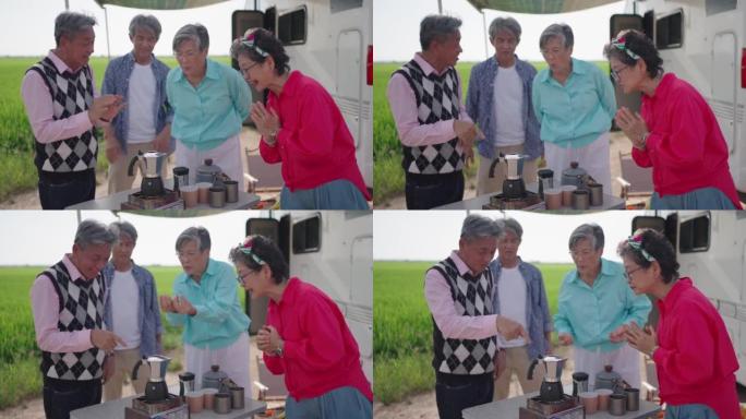 亚洲华裔资深朋友早上在稻田的露营车旁等待咖啡沸腾