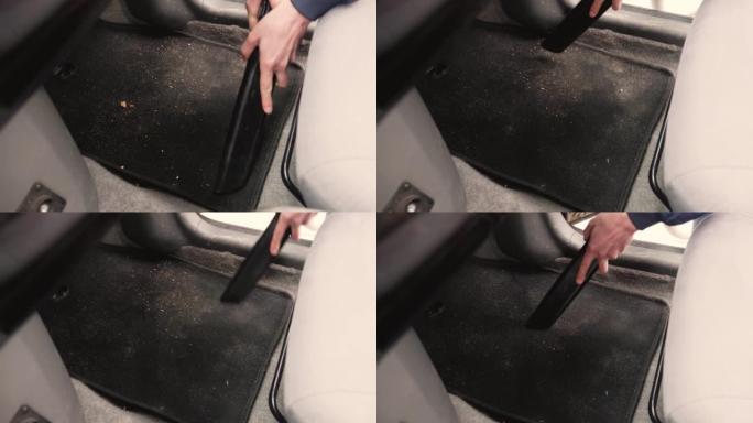 男子司机用真空吸尘器清洁汽车座椅和内饰