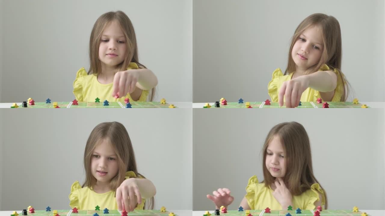 小女孩玩五颜六色的人物。棋盘游戏和儿童休闲概念