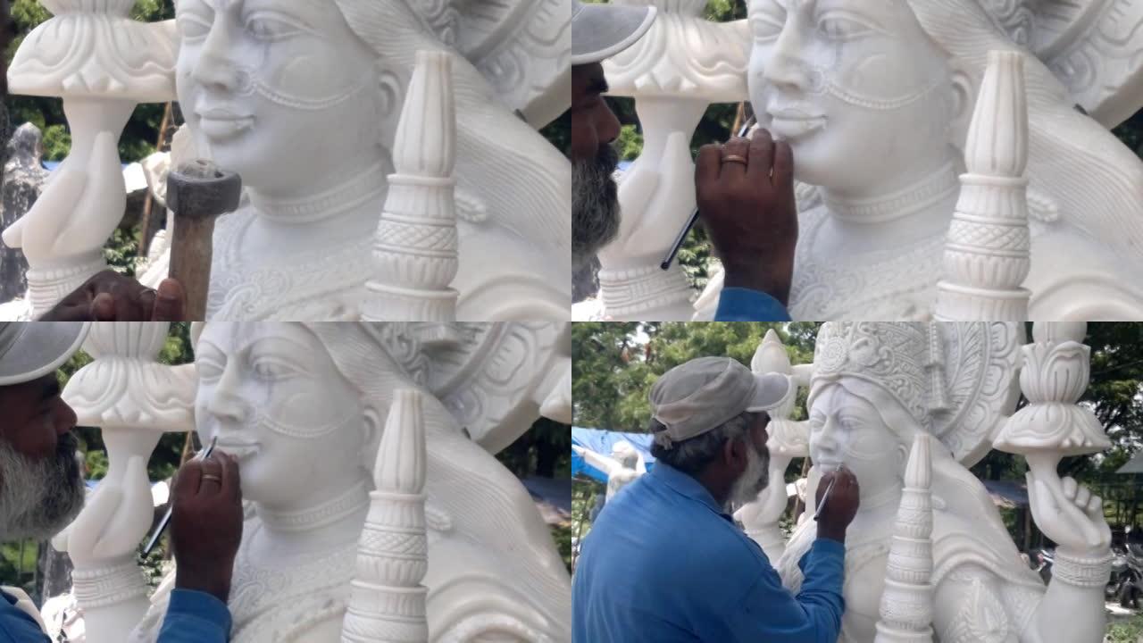 印度工匠雕刻传统印度教女神拉克希米或拉克西米白色大理石石雕或雕像出售，使用锤子和凿子，手工移动。