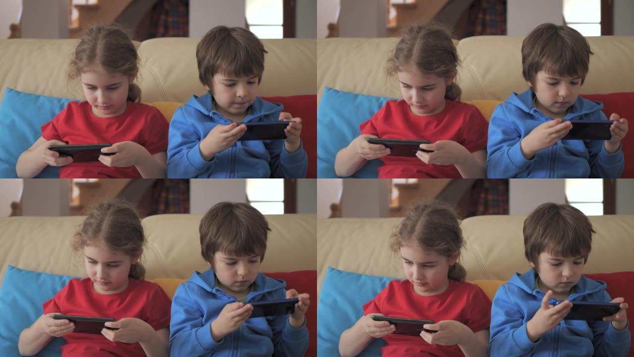 孩子们在家里的沙发上用手机玩游戏。孩子们在手机上玩视频游戏。男孩和女孩在沙发上玩视频游戏智能手机朋友