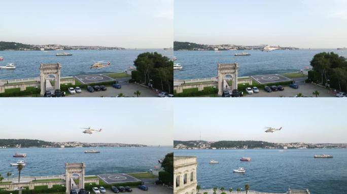 空中直升机在伊斯坦布尔博斯普鲁斯海峡上空飞行，直升机起降区，直升机停机坪鸟瞰图，黄金色直升机，飞行直