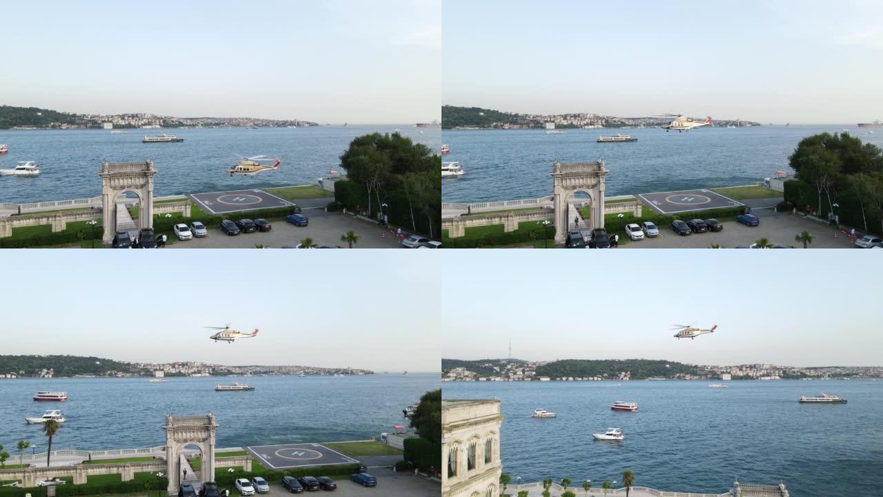 空中直升机在伊斯坦布尔博斯普鲁斯海峡上空飞行，直升机起降区，直升机停机坪鸟瞰图，黄金色直升机，飞行直