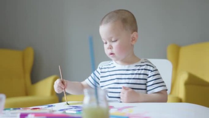 小艺术家可爱的孩子在家用画笔在客厅画画