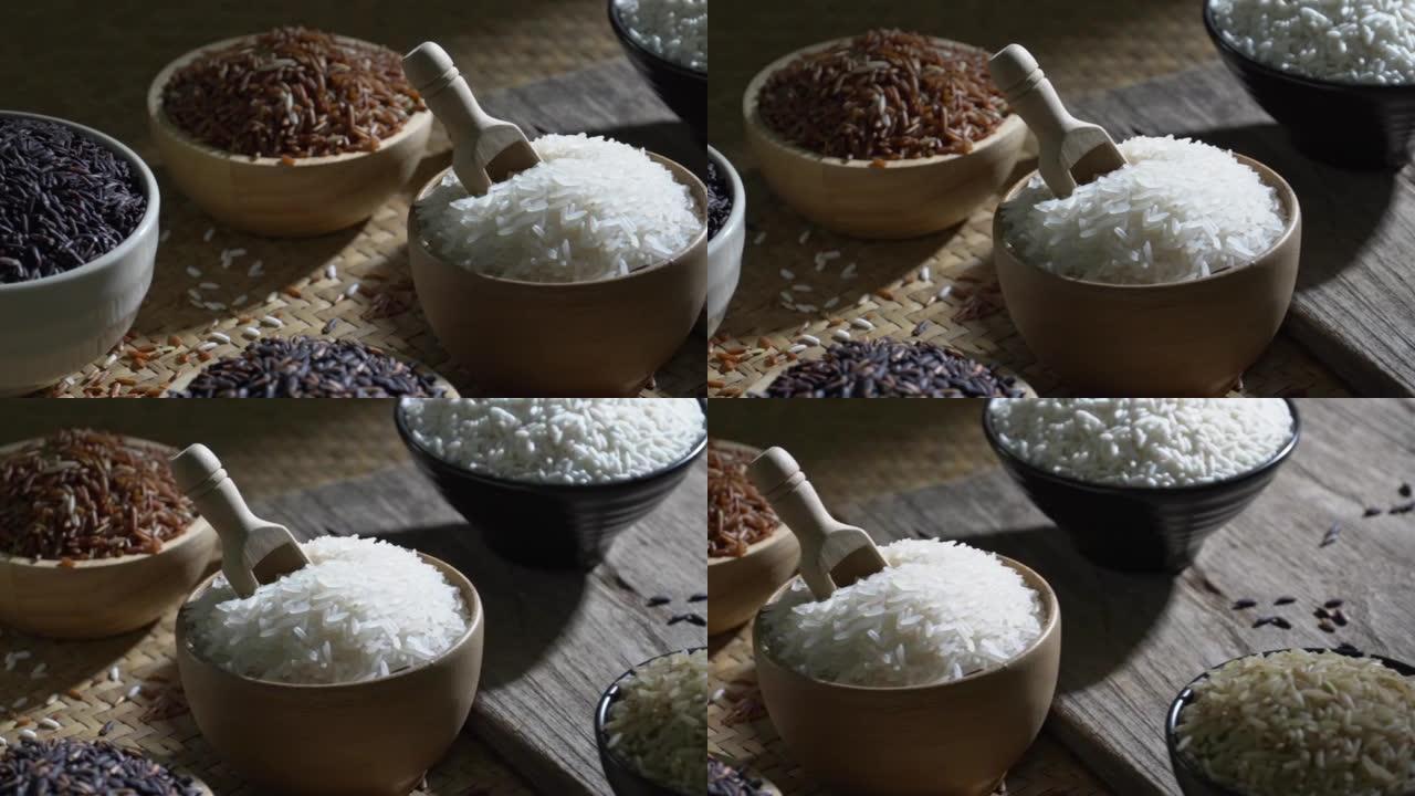有机糙米和亚洲黑米饭，木桌碗中的茉莉白米饭，有机天然食品概念的未煮熟产品