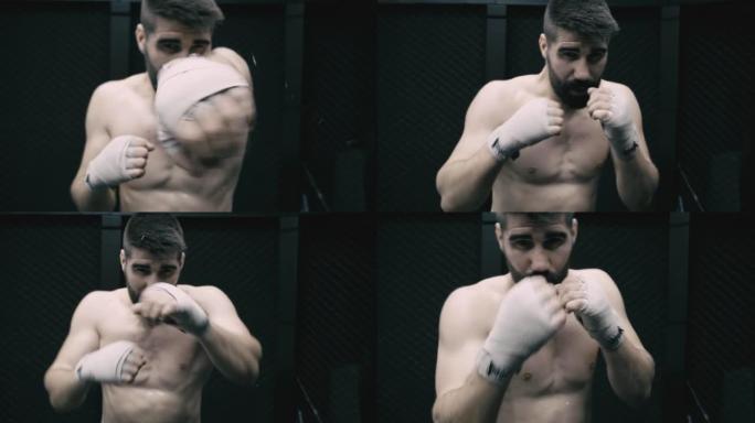 Male athlete training boxing moves in empty factor