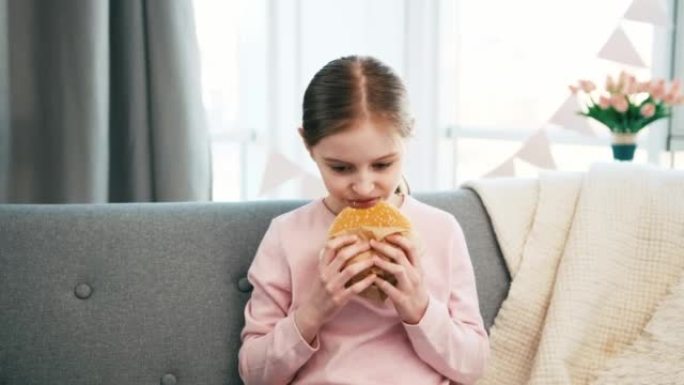 Little girl eating hamburger