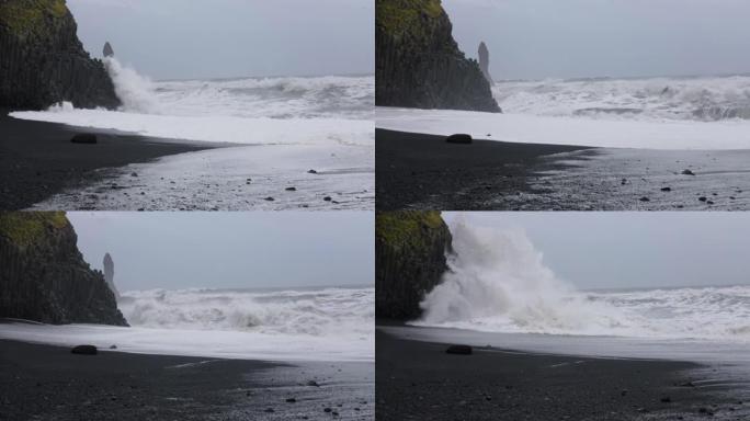 黑沙滩上的海浪撞击岩石