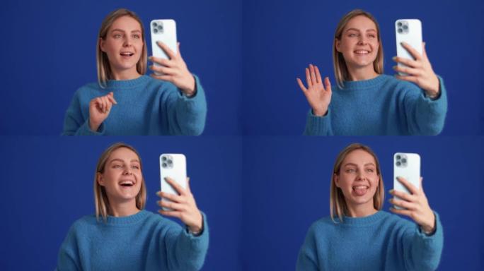 Smiling woman wearing blue sweater talking by vide