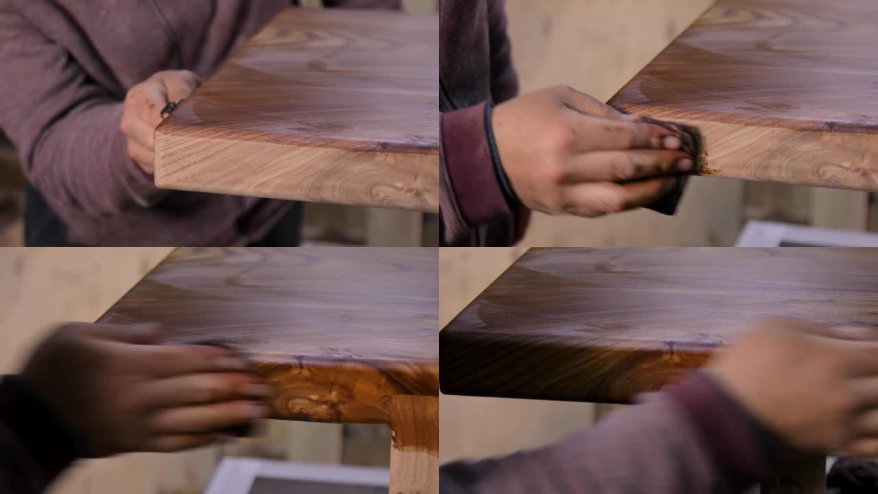 木匠在木桌上涂上保护性亚麻籽油的特写镜头