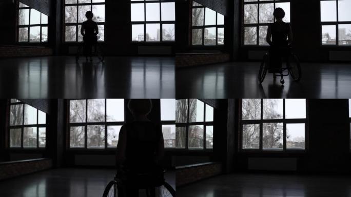 残疾女性舞者靠窗的剪影