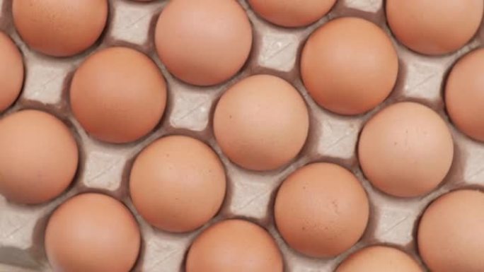 鸡蛋，旋转射击，纸箱包装中的鸡蛋，俯视图，鸡蛋生产概念。