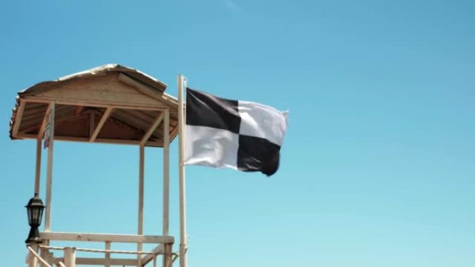 水上运动区悬挂旗帜，禁止在海上游泳。旗帜在风中飘扬。海上沙滩上的安全与风险。危险的安全区域。海滩上的