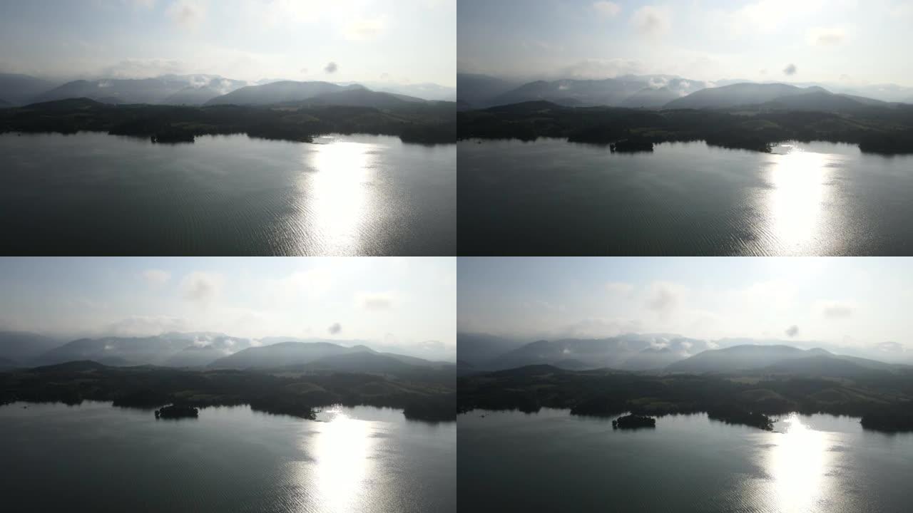 带着雾气飞越局部山脉和湖泊。航拍视频