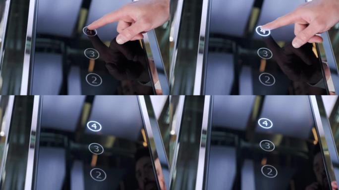 人的手按下现代玻璃电梯上的按钮。举升到办公室。办公室中心或酒店的男性手推电梯轿厢按钮。技术、进步、成