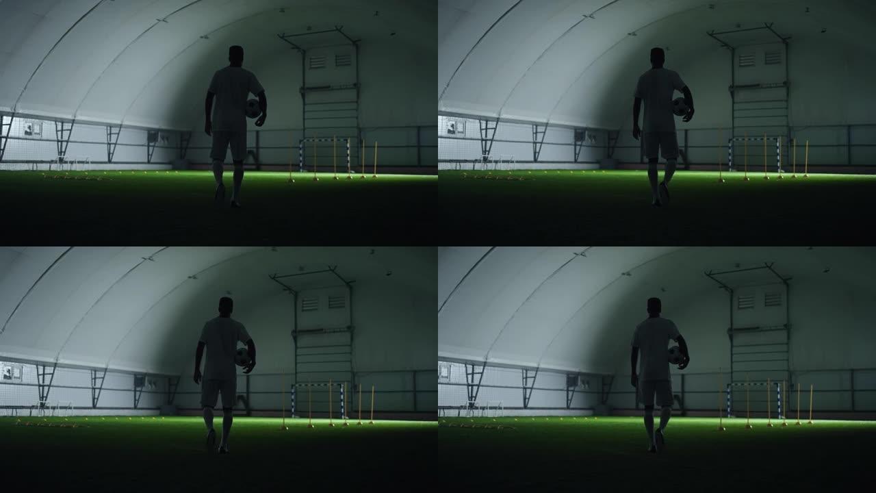 训练馆里有运动的男性形象，黑暗中足球运动员的后视，慢动作