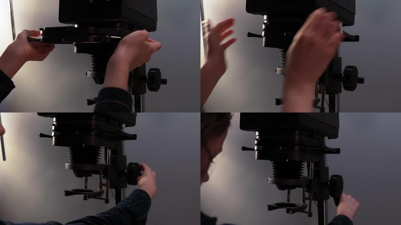 摄影师将载体放在放大镜中并设置正确的高度。