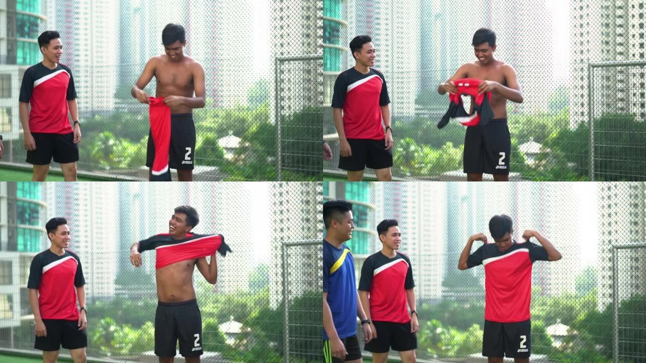 年轻的亚洲男子换上运动衫进行足球训练