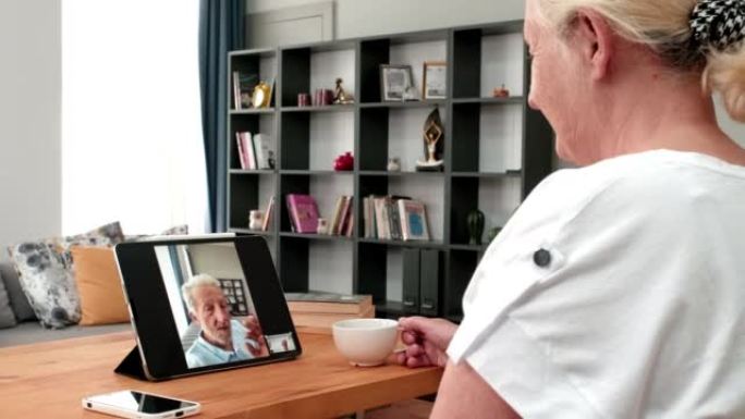 老妇人在数字平板电脑上使用在线约会应用程序