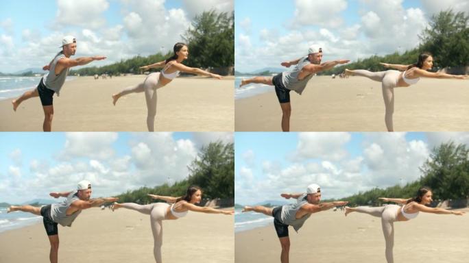 海滩上美丽的瑜伽女人和男人。年轻的Cuasian妇女在海滩上为她的朋友练习和教授瑜伽锻炼