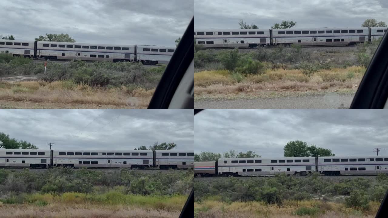 在科罗拉多州西部乡村慢动作视频系列中，在Amtrak大众运输旅客列车旁边行驶