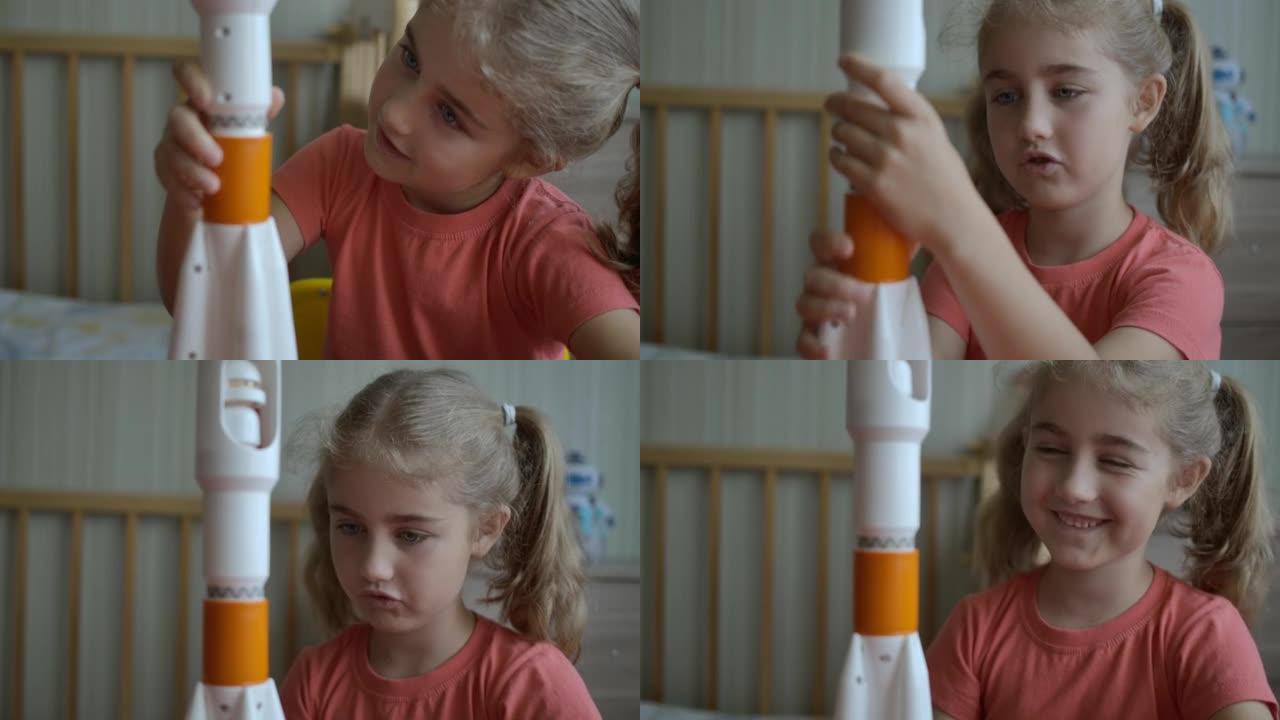 创意孩子玩玩具太空火箭。儿童梦想家玩玩具太空火箭。建造火星着陆任务火箭的小女孩。教育科学。