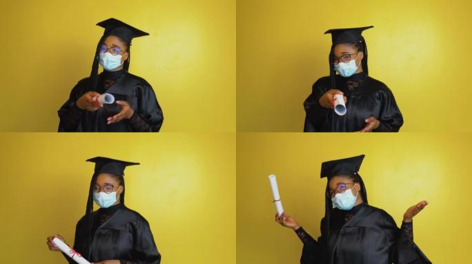 戴着防护罩的研究生手持文凭指向相机。穿着黑色长袍和黄色固体背景上的帽子的学生看着相机