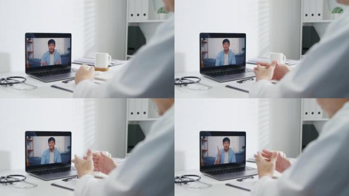 成熟的亚洲男性医生使用笔记本电脑视频呼叫医疗结果在咨询病人在健康诊所。