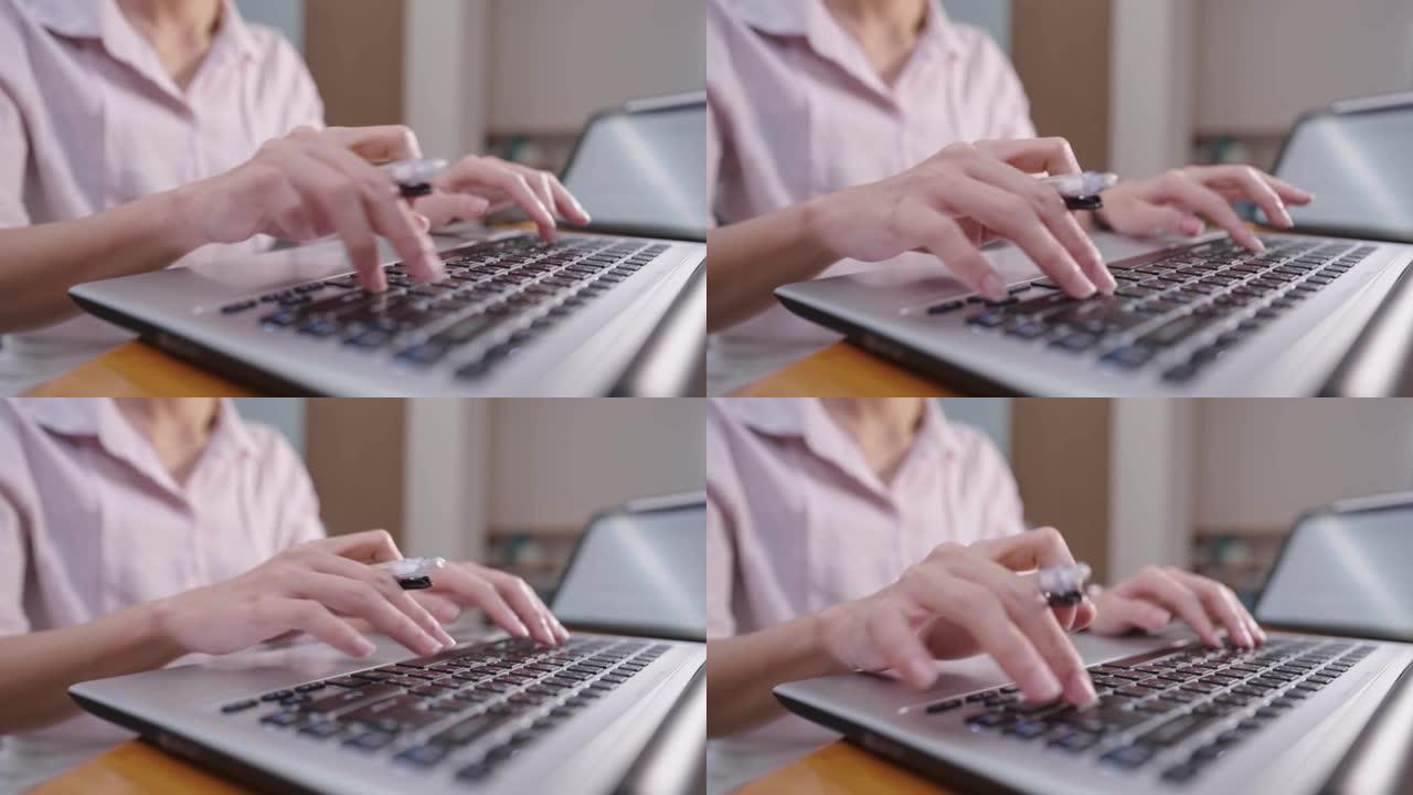 关闭女会计工作人员，手握笔的笔记本电脑在键盘上打字，财务管理工作狂女士，多任务工作的女人，最后期限独