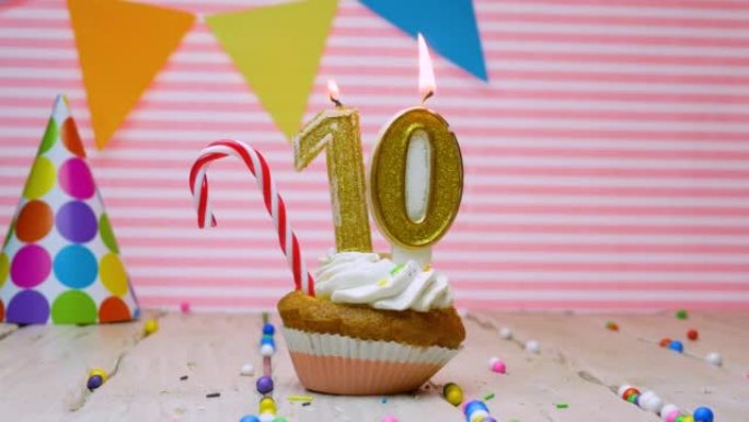 祝一个十岁的孩子生日快乐，一个美丽的视频背景，一个十岁的生日快乐在粉红色的背景上，一个奶油纸杯蛋糕和
