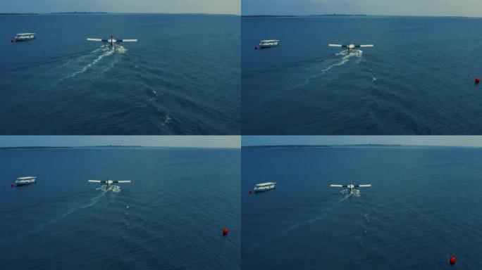 水上飞机的鸟瞰图从马尔代夫的蓝色海水中起飞