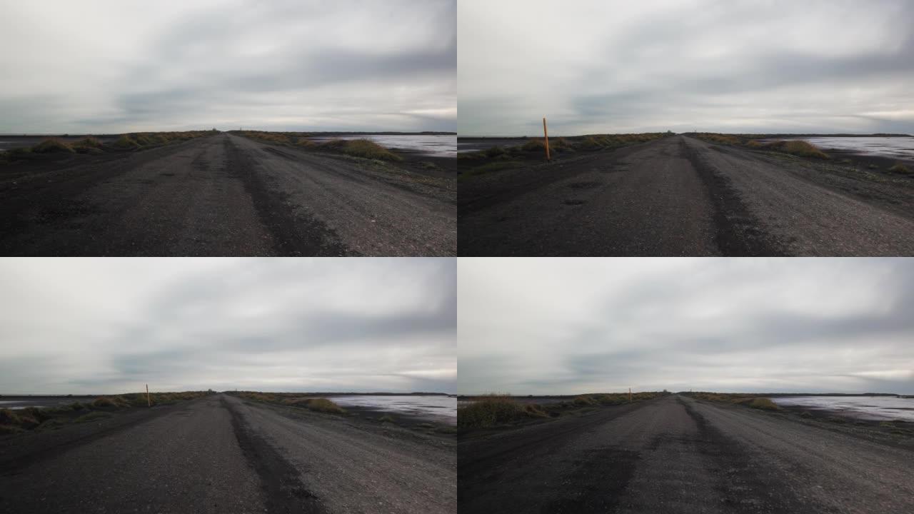 冰岛沿河的泥泞道路上行驶的汽车的景色