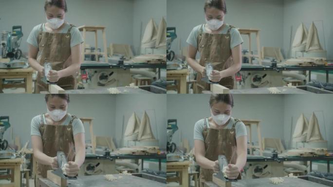 小企业主木匠制作家具制造车间的肖像
