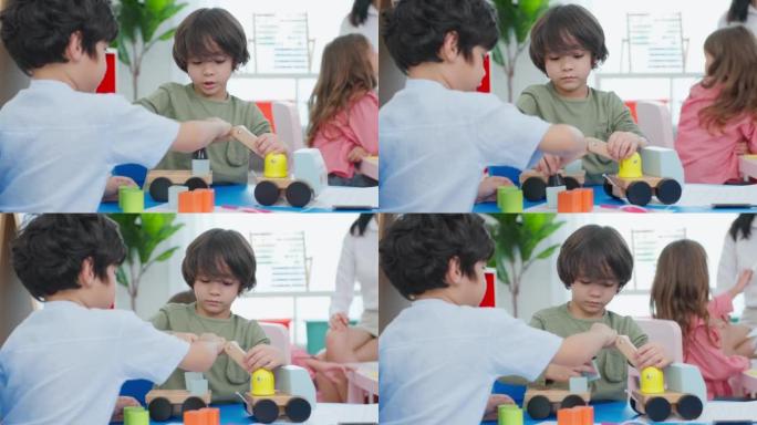幼儿学生在学校一起玩耍的混血群体。幼儿园的小女孩和小男孩朋友在幼儿园课间休息时花时间玩玩具时感到快乐