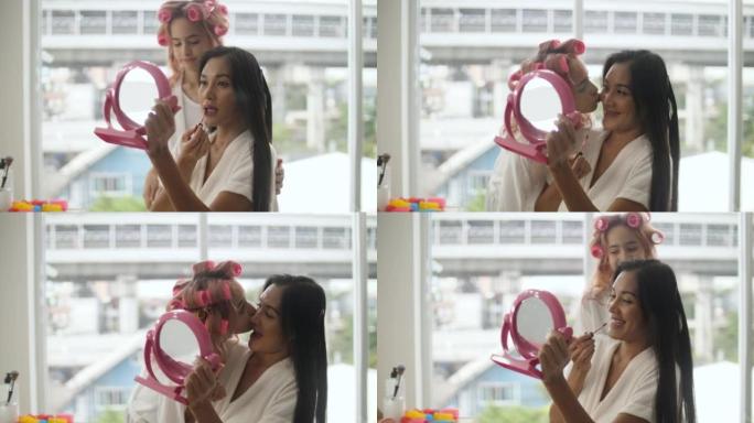 快乐的亚洲小女孩与母亲在家里、家庭和美丽的概念一起化妆